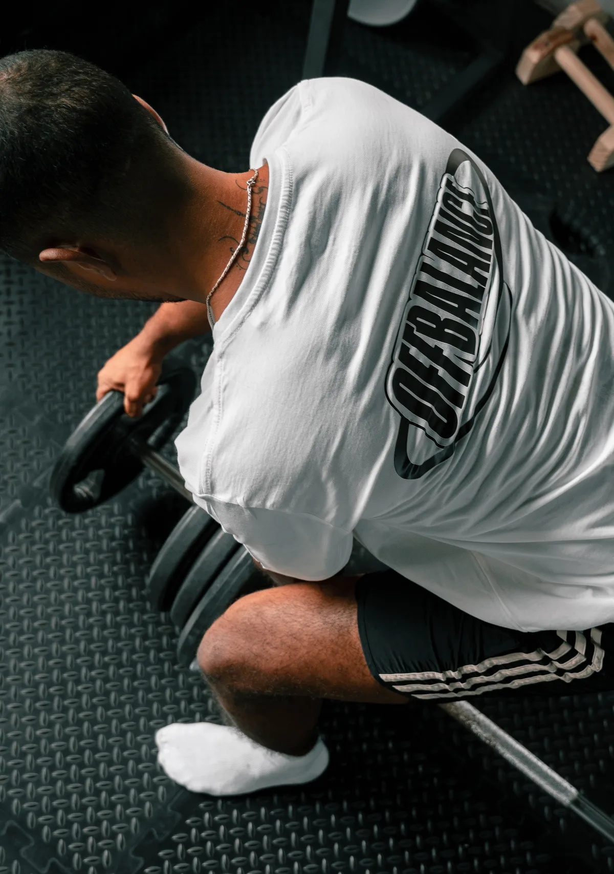 CJ setting up a barbell for a lift