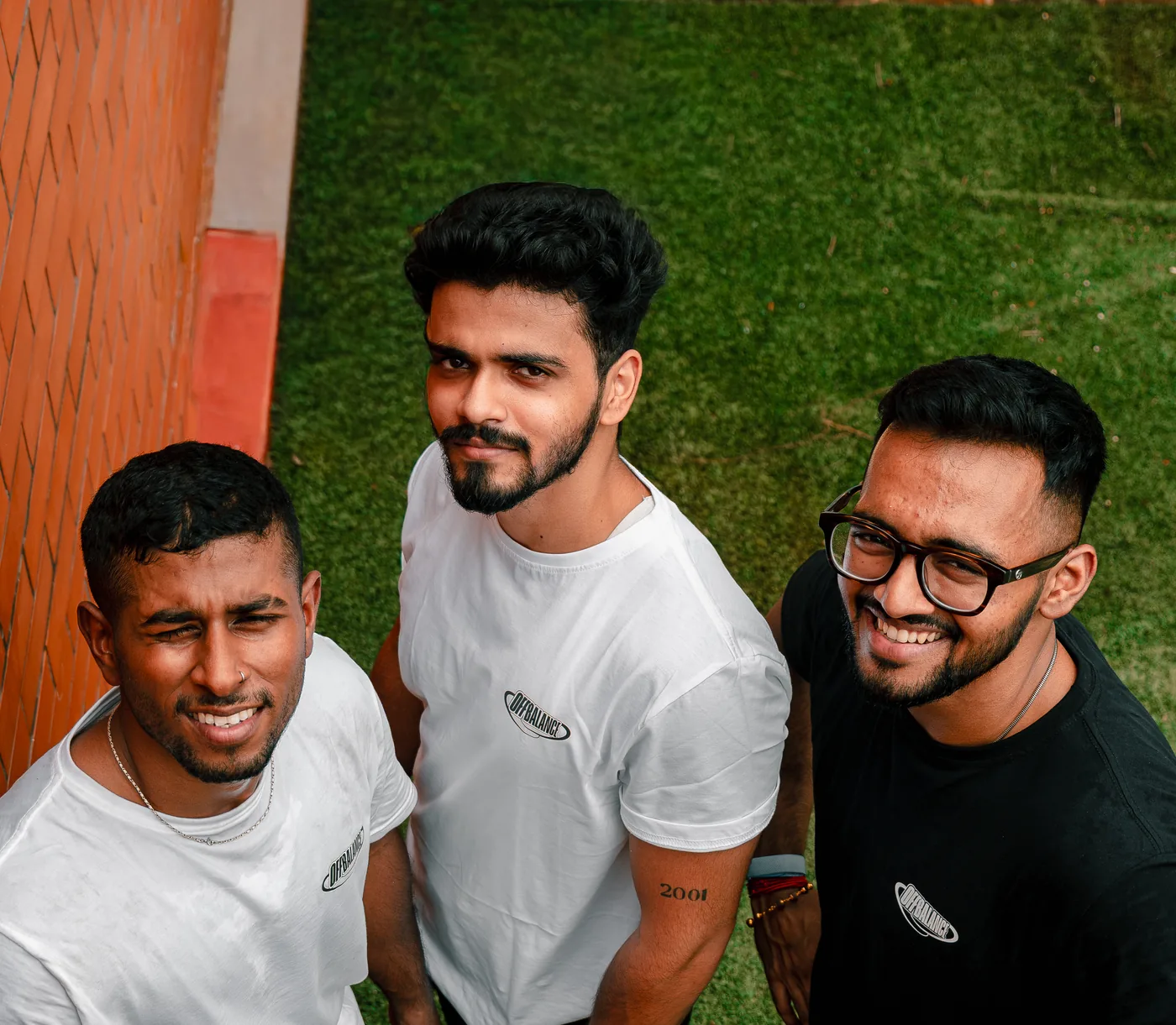 Three members of the Off Balance team looking up at the camera in Off Balance shirts