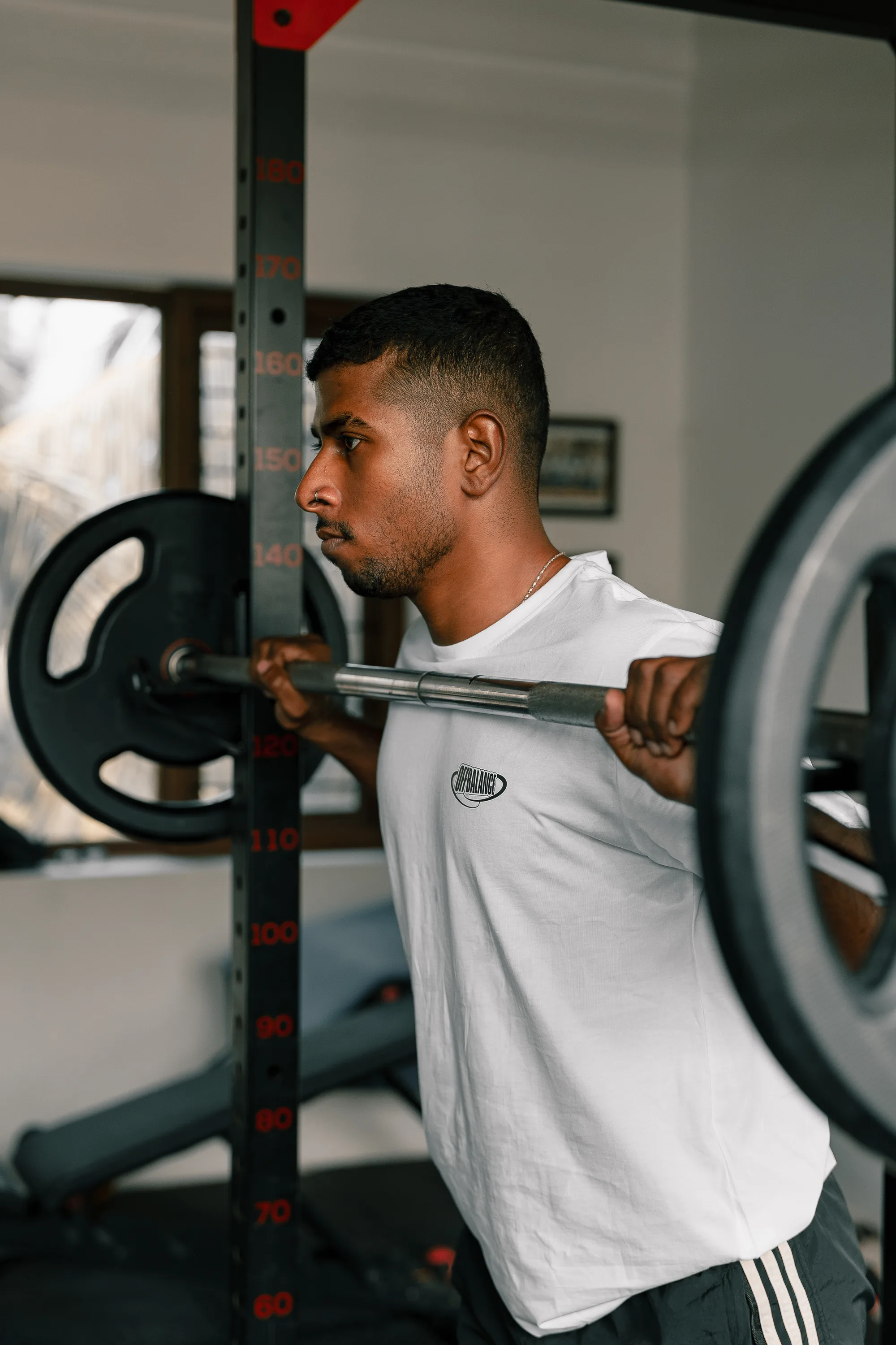 Off Balance fitness coach CJ training with a barbell